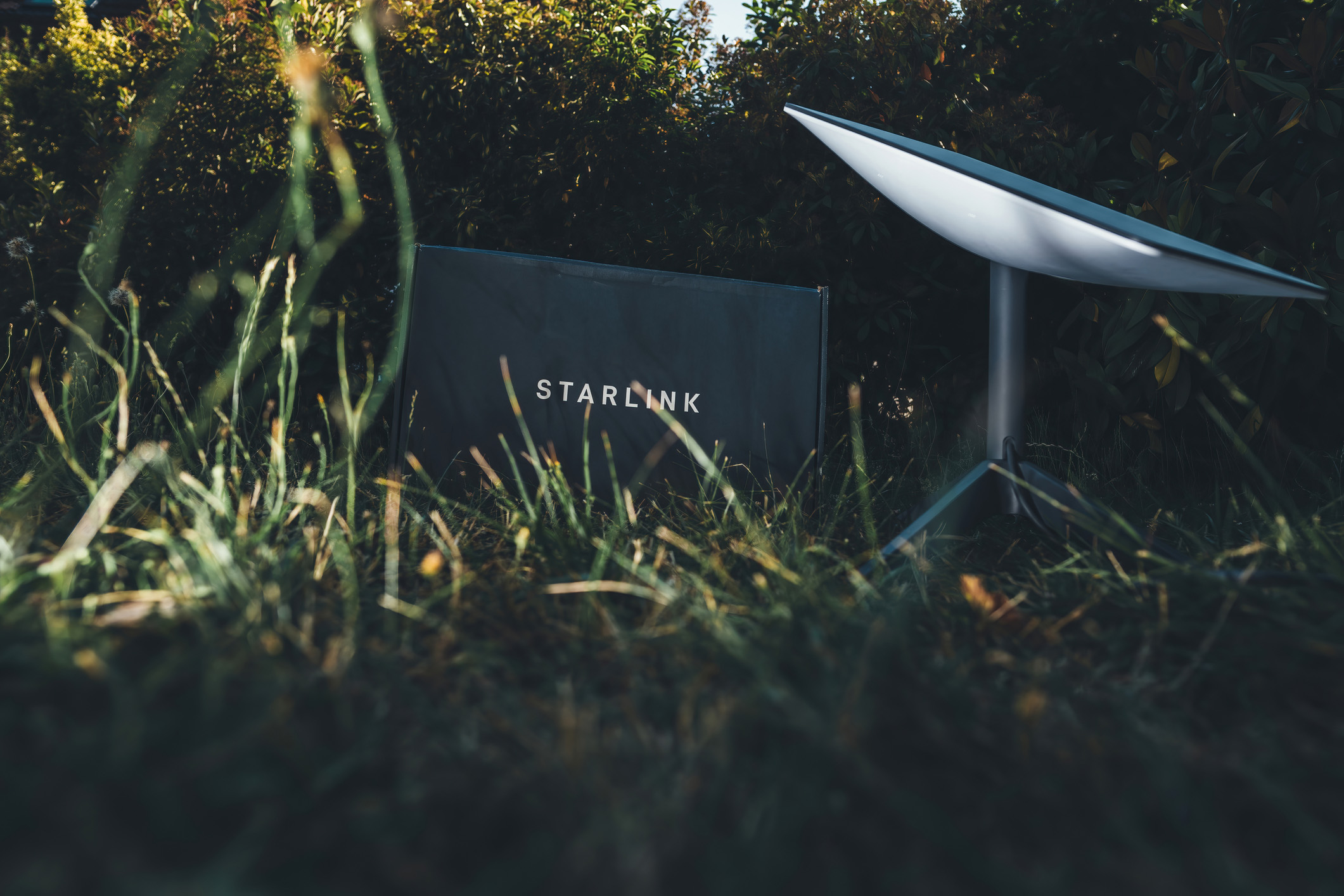 Sunset unboxing of spacex starlink internet antenna. Germany - Jun 16, 2023: Experience the new frontier in delivery with the Starlink system from SpaceX being unboxed in backyard garden. Reliable, speedy data transmission for your business, exploration, and communication needs.